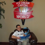 A United Way board member reading to a young child at the Blue Bunny Ice Cream Parlor (Le Mars, IA - 2012)