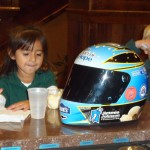 A young participant in the United Way's literacy program enjoying her Blue Bunny ice cream with the Blue Bunny Helmet of Hope (Le Mars, IA - 2012)
